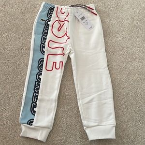 Lacoste NWT toddler boy size 4 white, red, navy and light blue logo joggers.